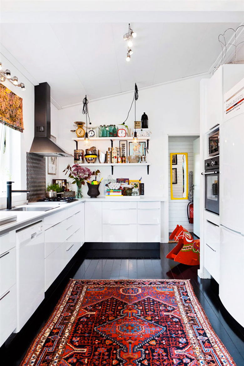 red persian rug in a kitchen on a black floor