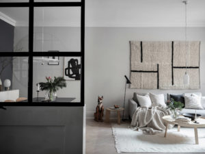 nordic style living room with a hanged rug in the back