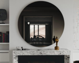 smoked glass mirror above fireplace