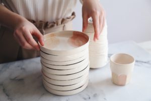 Ceramic Studio Maitoinen - plates in pile and hands