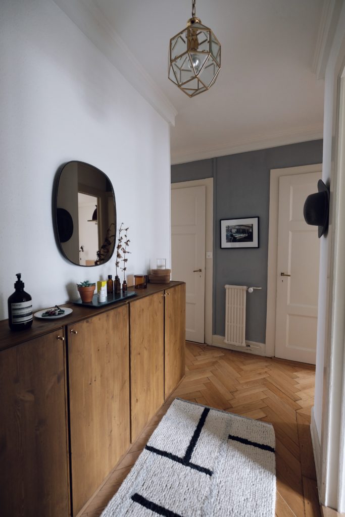 entryway mirror with cupboard and rounded rectangular mirror