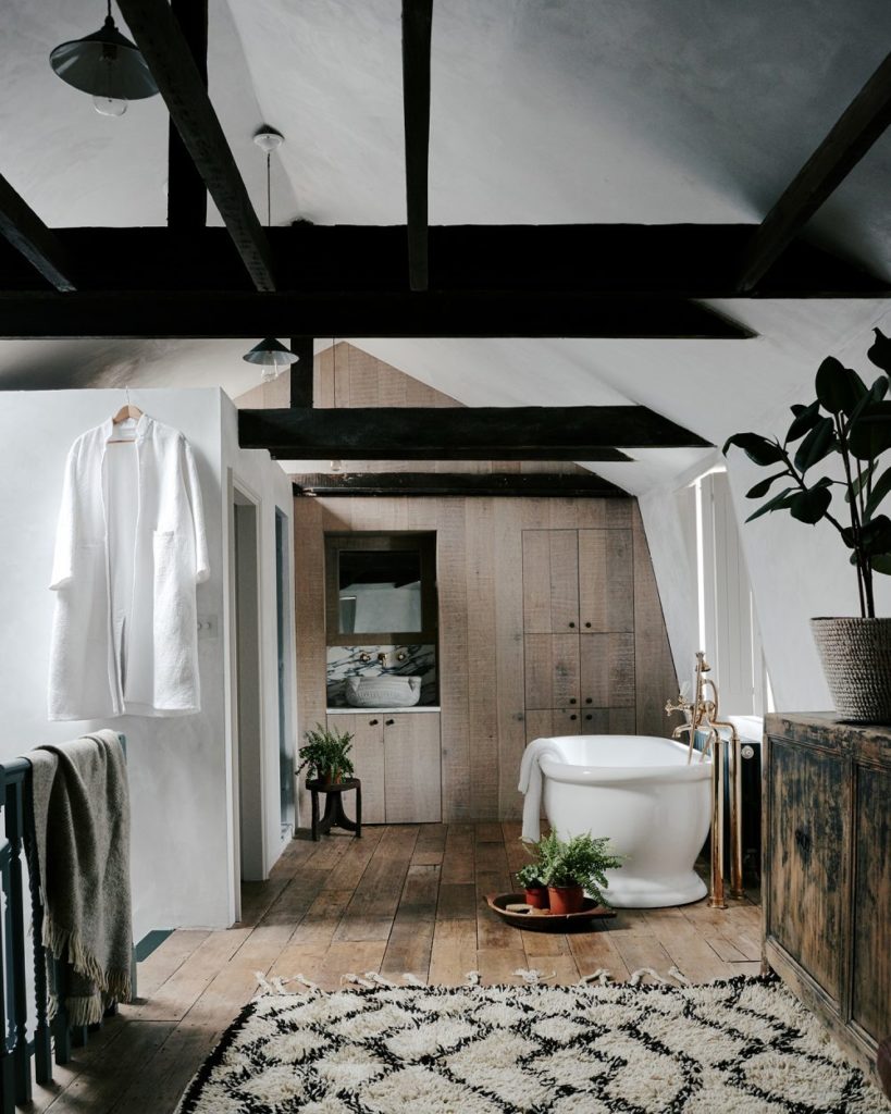 the en-suite bathroom with the oak cabinetry that reflects the wabi-sabi elegance