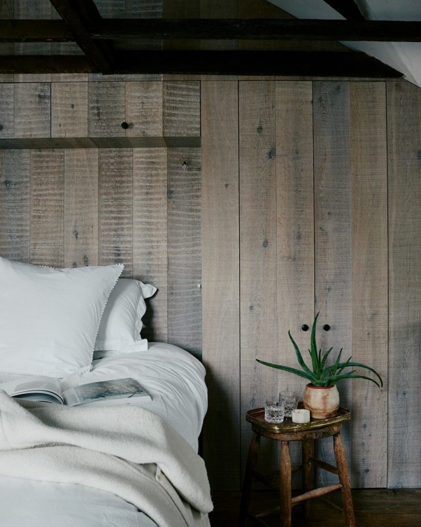 close up of the bed with oak cabinetry