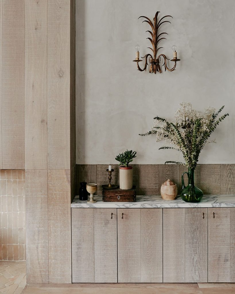 the oak cabinetry and the stone countertop