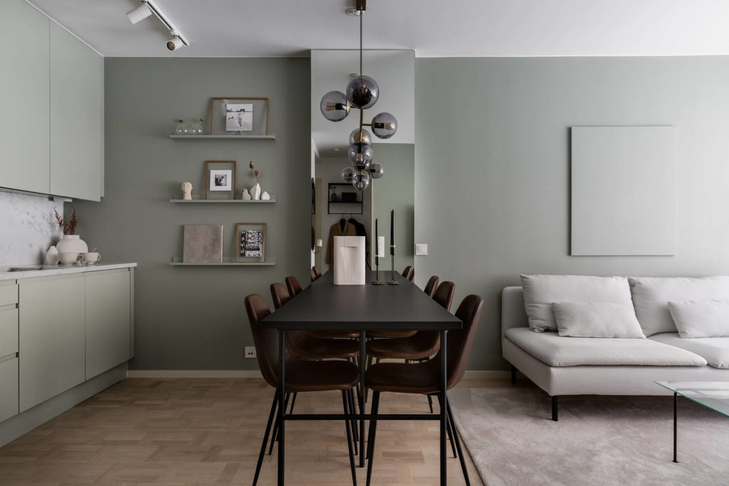 open plan living area with sage green walls dining room