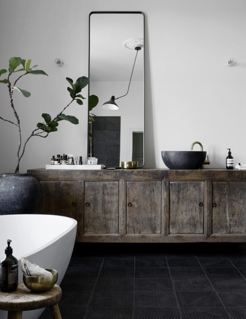 black and white bathroom with vintage sideboard