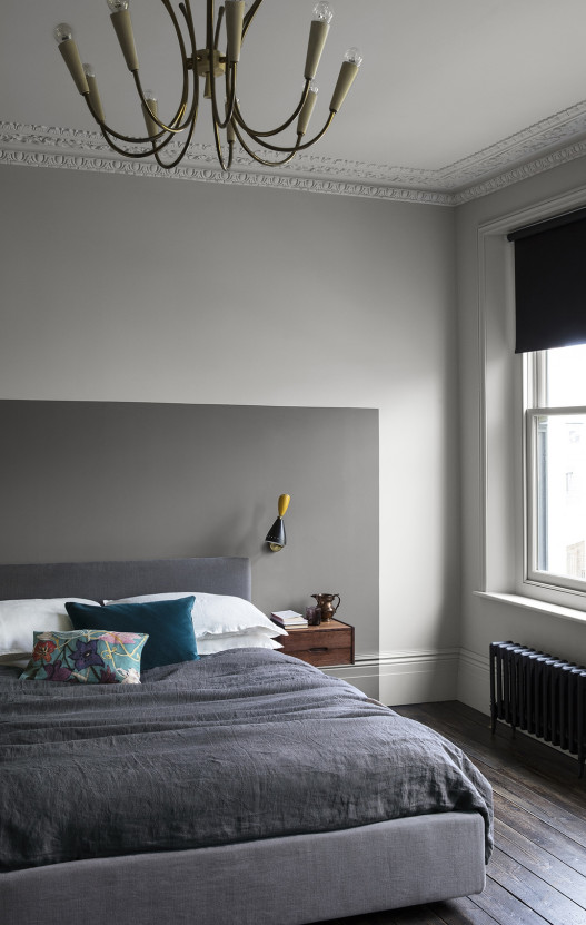 white bedroom with a grey headboard painted on the wall