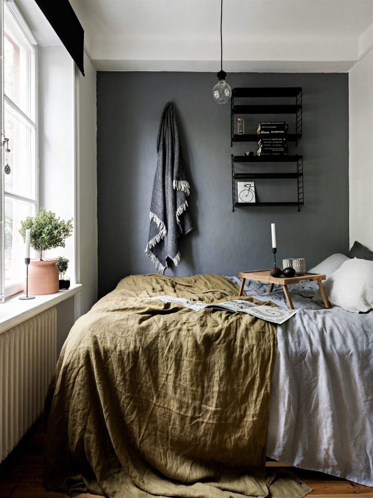 small bedroom with one dark wall