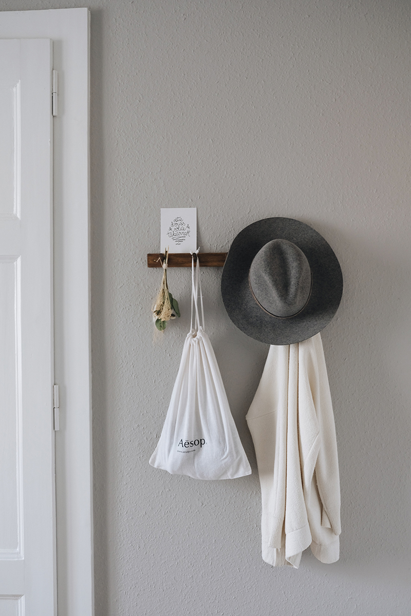 a styled peg rail in a bedroom