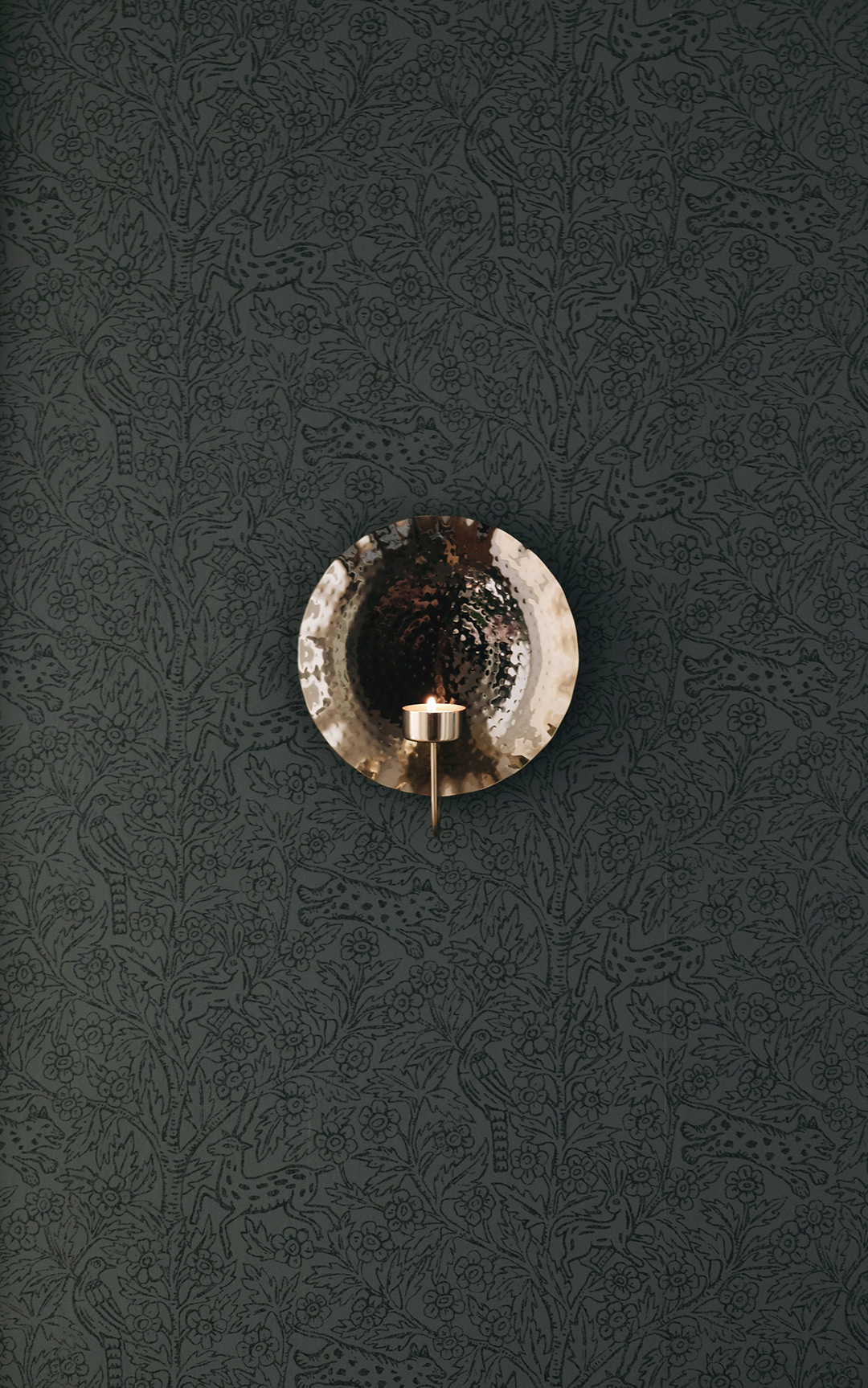 H&M home brass candle sconce on dark green wallpaper