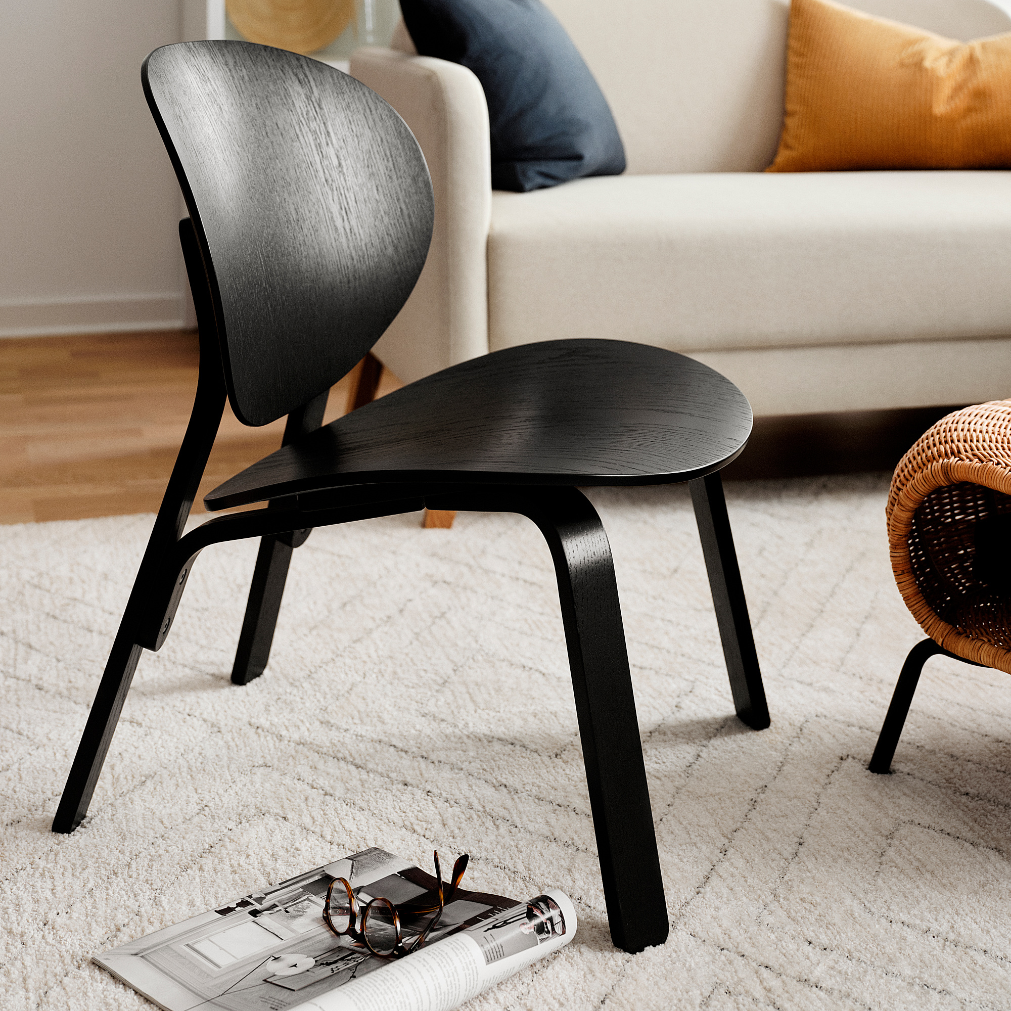 FRÖSET black stained oak veneer easy chair in a living room