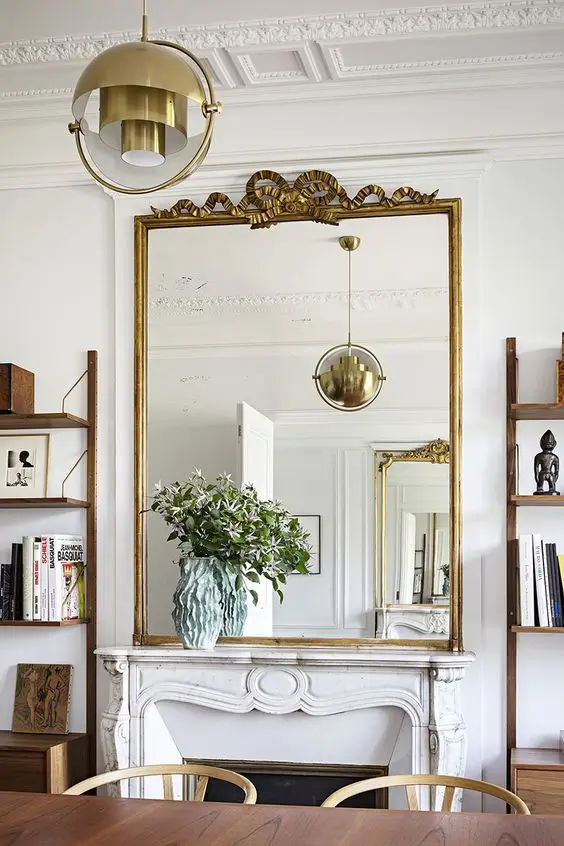 antique gold mirror in living room above fireplace
