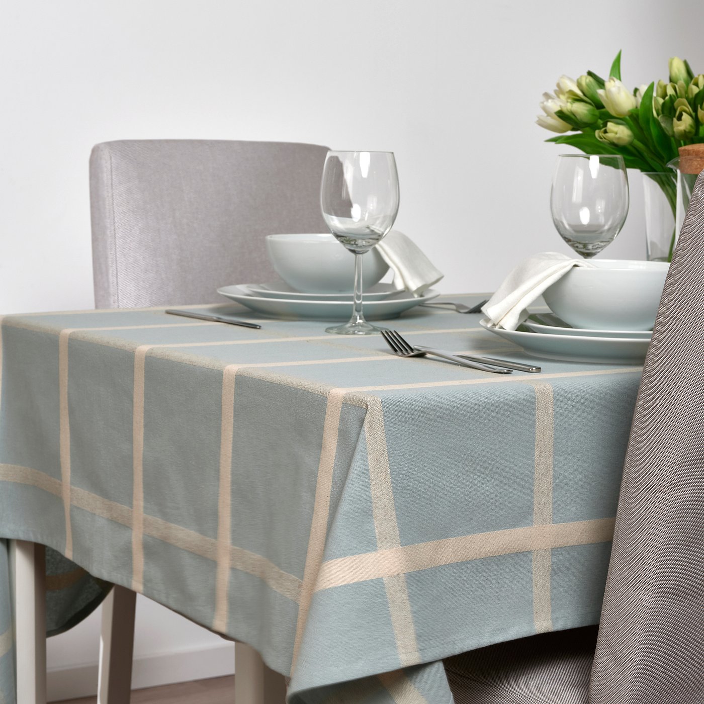 IKEA NISSÖGA blue checked tablecloth on a dining table